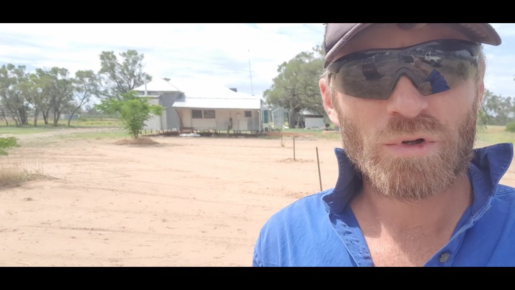 Scott with sandy dirt for new grass area in the background